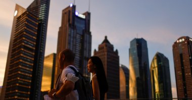 People walk in Lujiazui financial district during sunset in Pudong, Shanghai, China, July 13, 2021. (Reuters Photo)