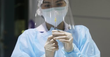A Thai health official prepares a dose of vaccine against COVID-19 at a vaccination center, set up inside the Bang Sue Grand Station in Bangkok, Thailand, July 28, 2021. (EPA Photo)