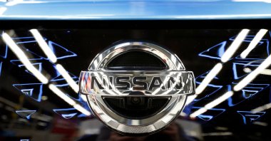 The logo of Nissan is seen on a car ahead of a news conference at Nissan's Sunderland plant in Sunderland, U.K., July 1, 2021. (Reuters Photo)