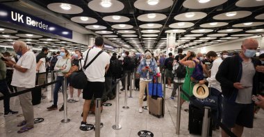 Arriving passengers queue at U.K. Border Control at Terminal 5 at Heathrow Airport in London, Britain June 29, 2021. (Reuters Photo)