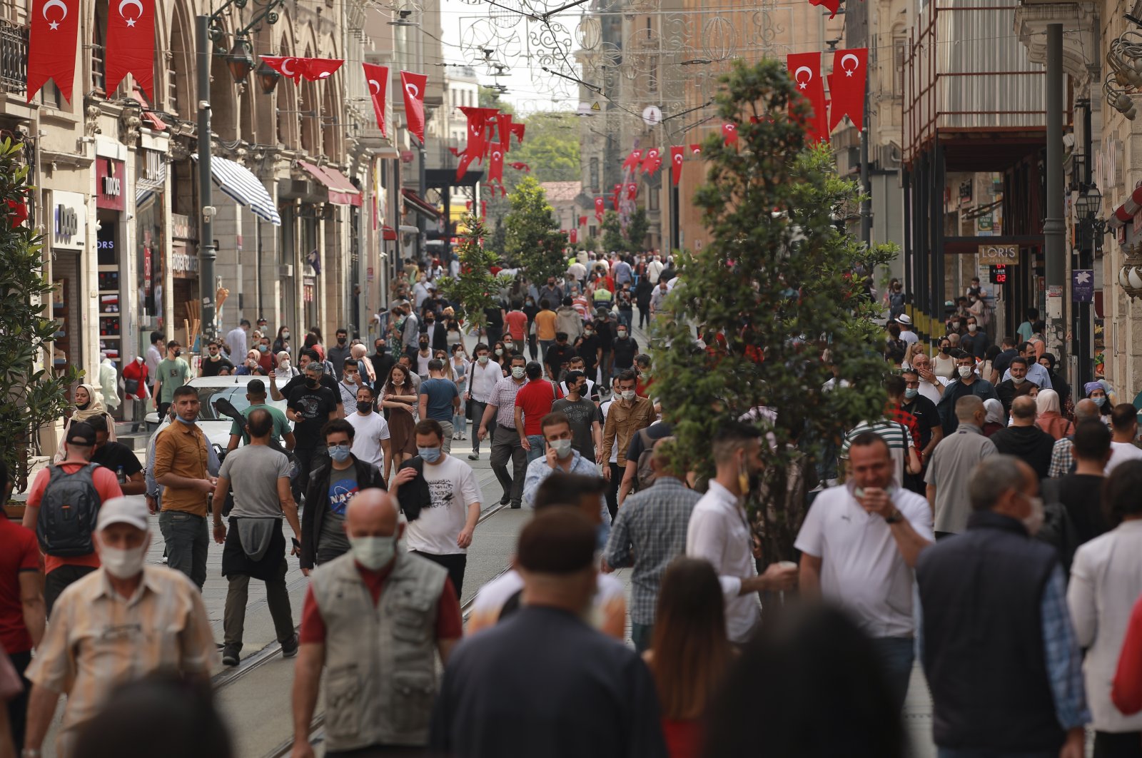 People walk in Istiklal Street, the main shopping street of Istanbul, Turkey, May 28, 2021. (AP Photo)