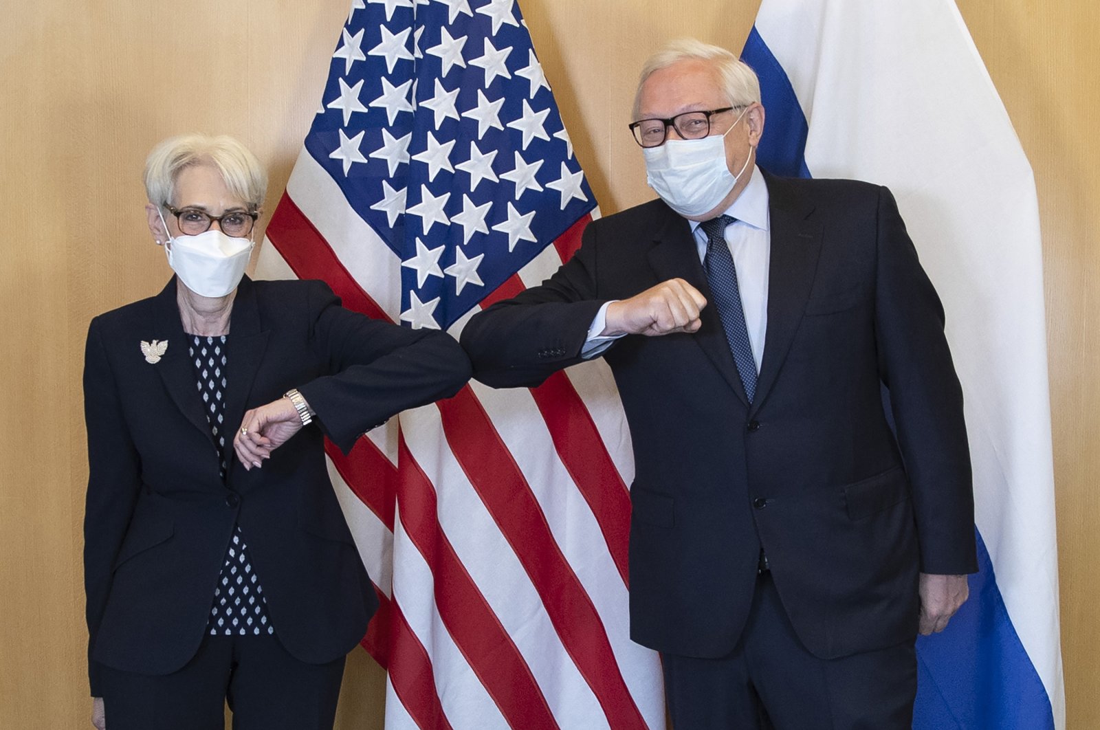 U.S. Deputy Secretary of State Wendy Sherman and Russian Deputy Foreign Minister Sergey Ryabkov greet each other at the start of their meeting in Geneva, Switzerland, July 28, 2021. (US Mission Geneva via AP)