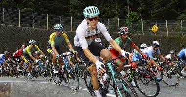Dmitriy Gruzdev of Kazakhstan, Nikias Arndt of Germany and Mohcine El Kouraji of Morocco compete in the men's cycling road race at the 2020 Summer Olympics, Oyama, Japan, July 24, 2021. (Pool Photo via AP)