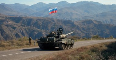 A member of the Russian peacekeeping troops walks by a tank near the border with Armenia, in the region of Nagorno-Karabakh, Azerbaijan, Nov. 10, 2020. (Reuters Photo)