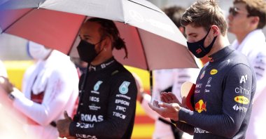 Red Bull driver Max Verstappen of the Netherlands and Mercedes driver Lewis Hamilton of Britain (L) stand on the grid before the start of the British Formula One Grand Prix, at the Silverstone circuit, in Silverstone, England, July 18, 2021. (AP Photo)