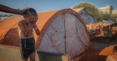 A child is seen near their tent in a camp for displaced people in Idlib, northwestern Syria, July 29, 2021. (AA Photo)