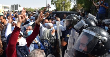 Supporters and opponents of coup chant slogans in front of parliament building during the demonstration, in capital Tunis, Tunisia, on July 26, 2021. (Getty Images Photo)
