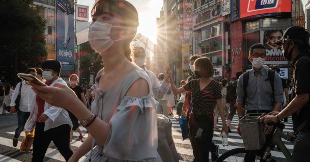People wear face masks in Tokyo a day after the city reported a record 2,848 new daily COVID-19 cases, Tokyo, Japan, July 28, 2021. (AFP Photo)