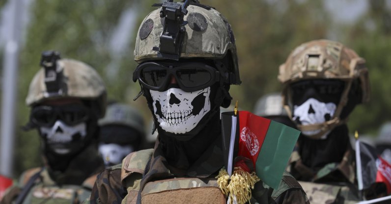 Masked Afghan Army Special Forces attend their graduation ceremony after a three-month training program at the Kabul Military Training Center, in Kabul, Afghanistan. July 17, 2021. (AP Photo)