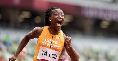 Marie-Josee Ta Lou, of the Ivory Coast, wins a heat in the women's 100-meter run at the 2020 Summer Olympics, in Tokyo, Japan, July 30, 2021. (AFP Photo)