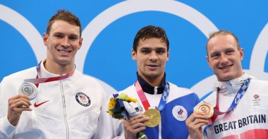 Evgeny Rylov of the Russian Olympic Committee (C), Ryan Murphy of the U.S. (L) and Luke Greenbank of Britain pose on the podium with the gold, silver and bronze medals respectively at Tokyo Aquatics Centre, in Tokyo, Japan, July 30, 2021. (Reuters Photo)