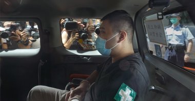 Tong Ying-kit, 23 years old, arrives at a court for the violation of the new security law after carrying a flag reading "Liberate Hong Kong, Revolution of our times" during a protest in Hong Kong, China, July 6, 2020. (AP Photo)
