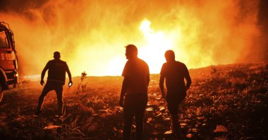 Firefighters and locals try to get the fire under control in Kirli village near the town of Manavgat, in Antalya, southern Turkey, July 30, 2021. (AP PHOTO) 