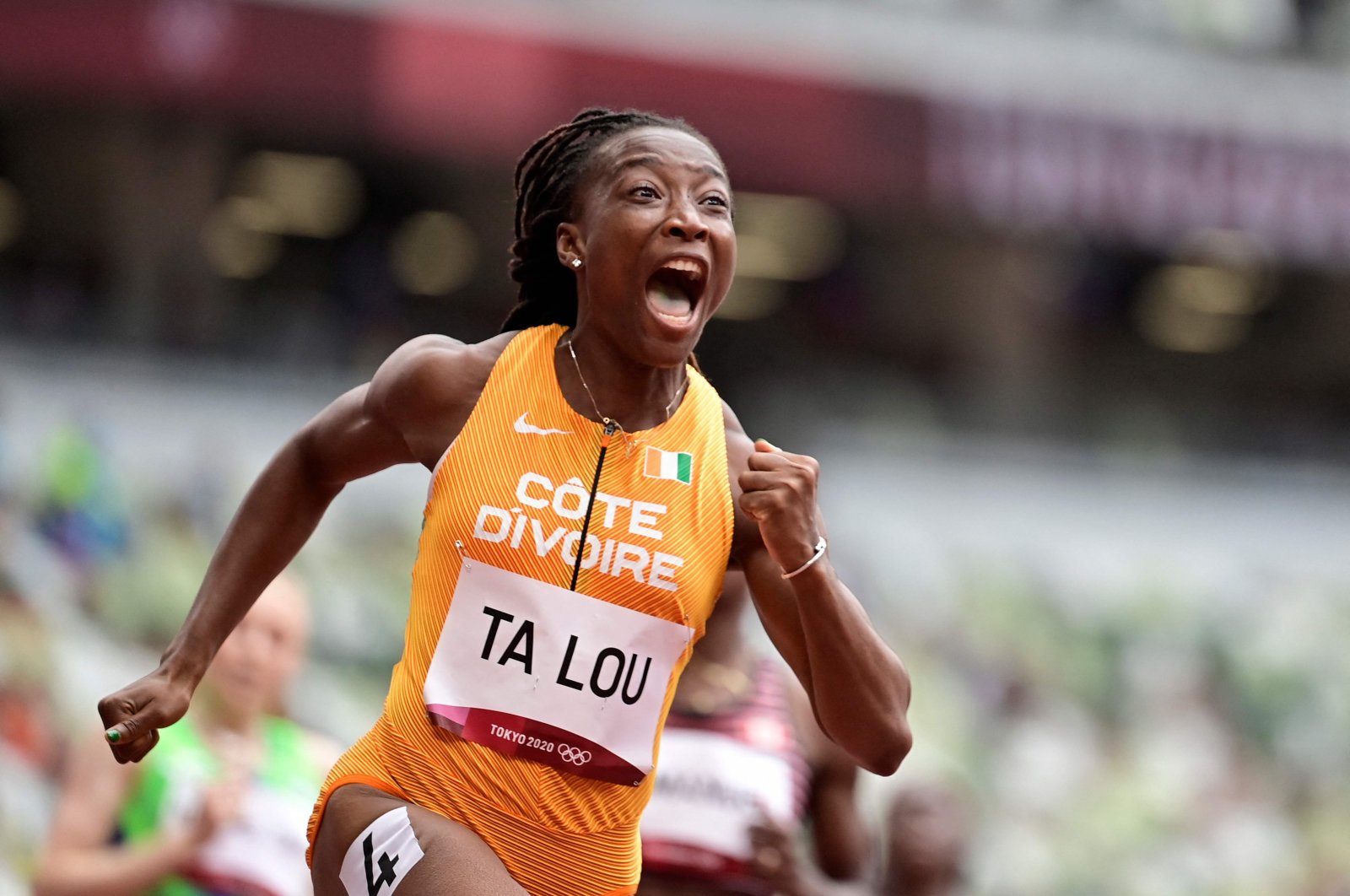 Marie-Josee Ta Lou, of the Ivory Coast, wins a heat in the women's 100-meter run at the 2020 Summer Olympics, in Tokyo, Japan, July 30, 2021. (AFP Photo)