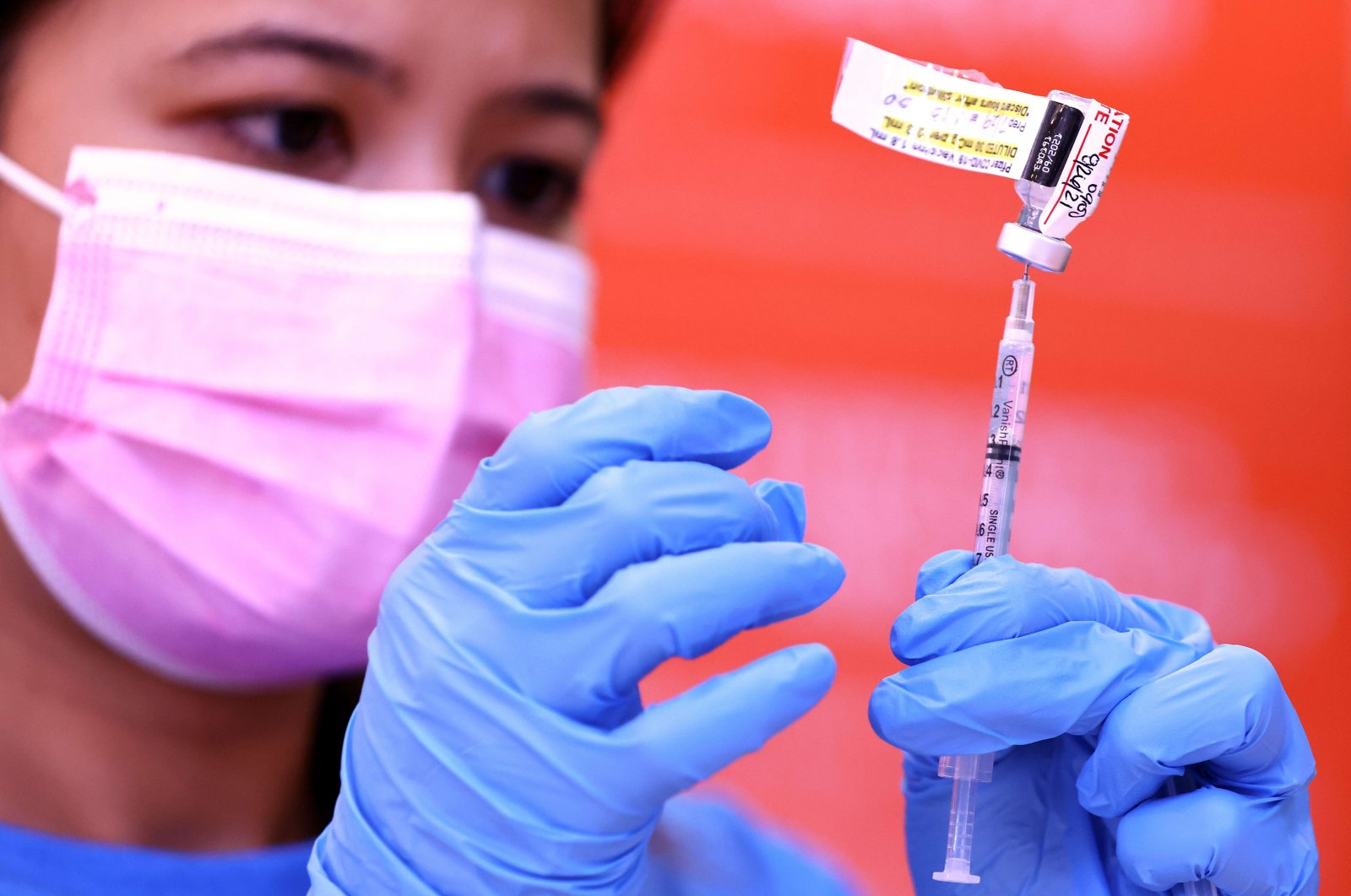 Registered nurse Darryl Hana prepares a dose of the Pfizer COVID-19 vaccine at a three-day vaccination clinic at Providence Wilmington Wellness and Activity Center on July 29, 2021 in Wilmington, California. (Getty Images/AFP Photo) 
