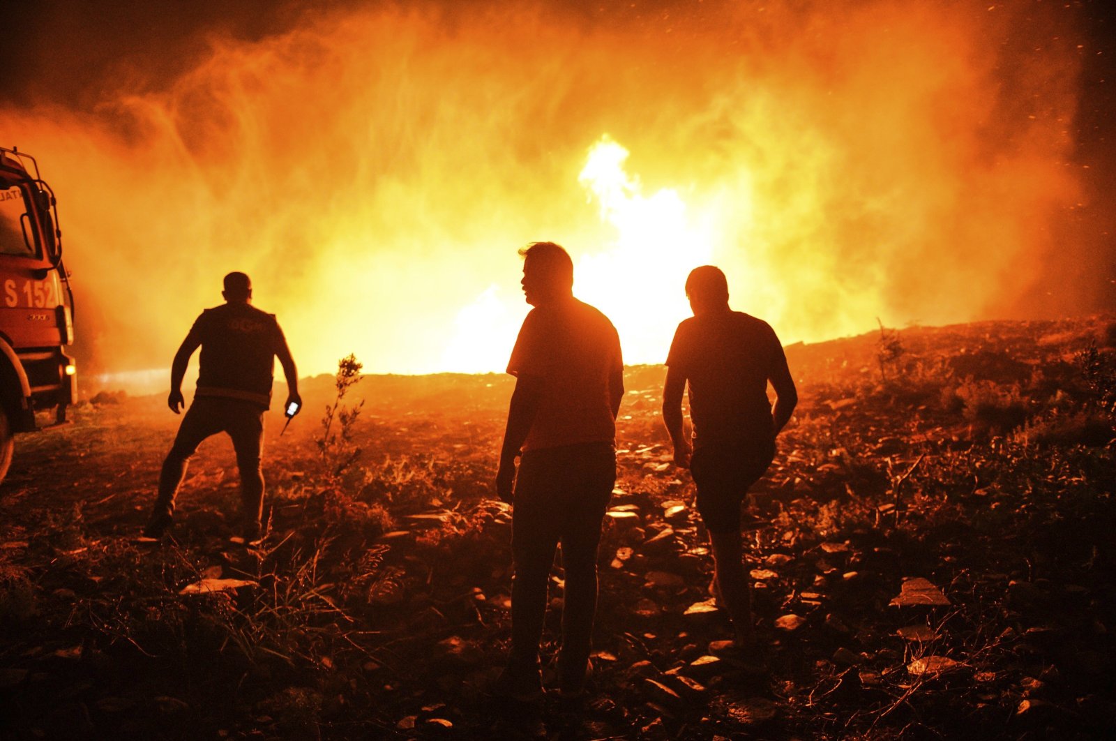 Firefighters and locals try to get the fire under control in Kirli village near the town of Manavgat, in Antalya, southern Turkey, July 30, 2021. (AP PHOTO) 