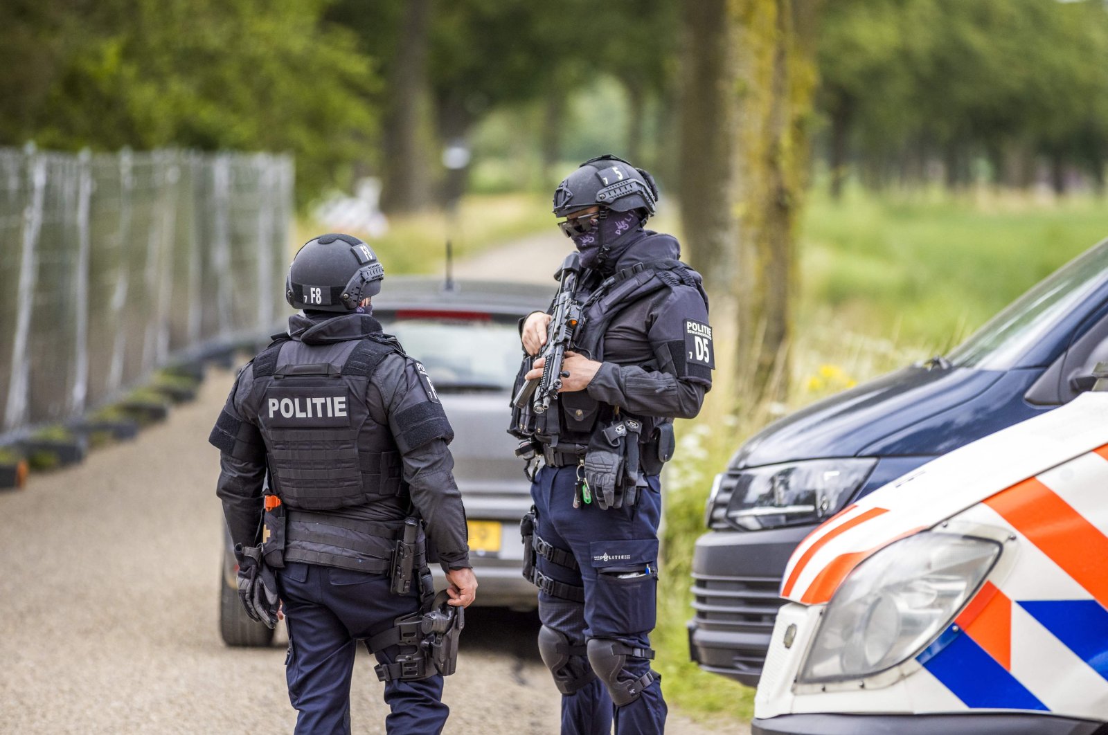 Policemen stand guard at the Hoogbosweg in Nederweert, as the police 'found the largest and most professional production location of crystal meth ever in the Netherlands' it said, July 30, 2021. (AFP File Photo)