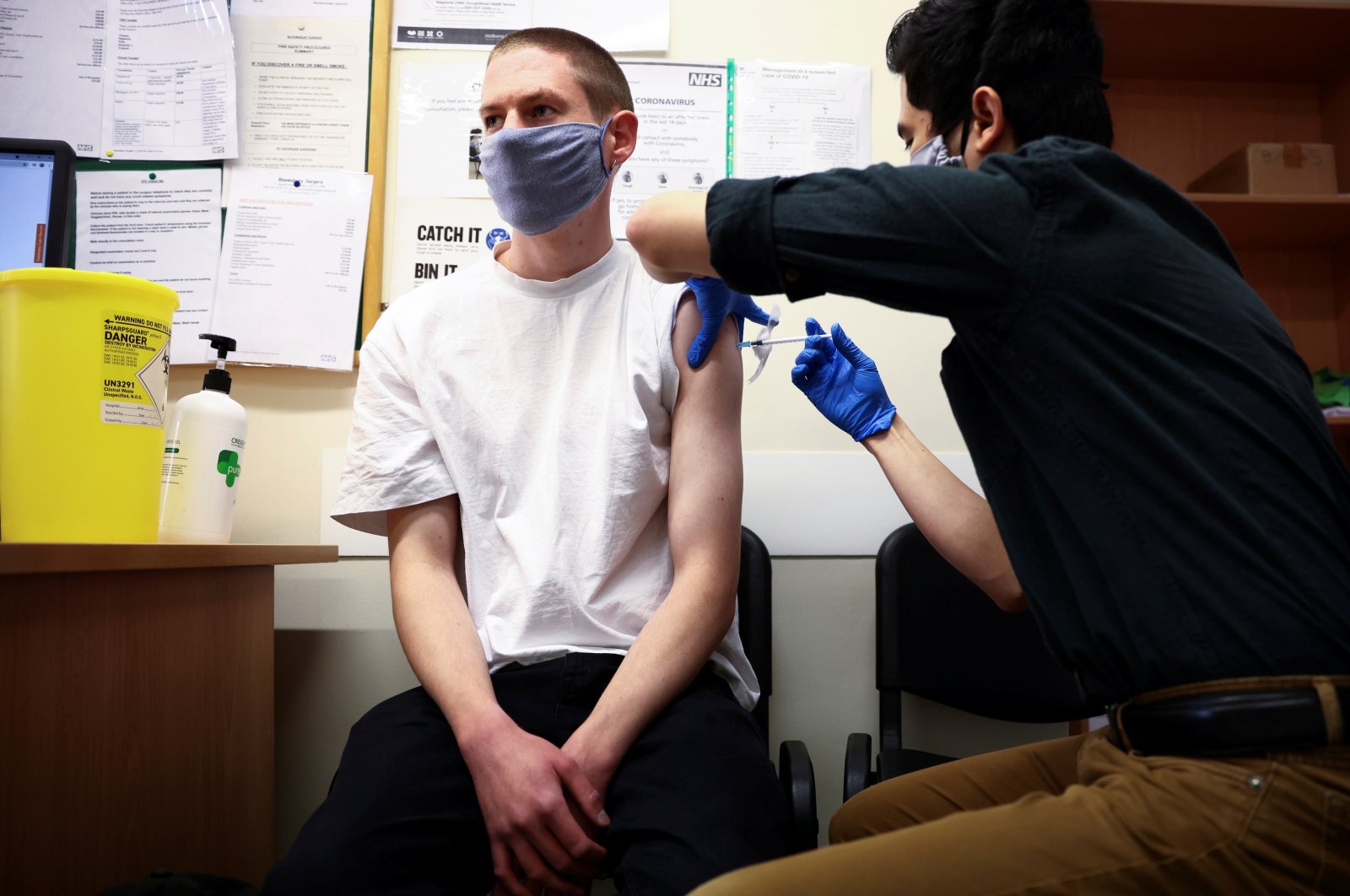 A person receives a dose of the Pfizer BioNTech COVID-19 vaccine at a vaccination center for young people and students at the Hunter Street Health Center in London, U.K., June 5, 2021. (Reuters Photo)