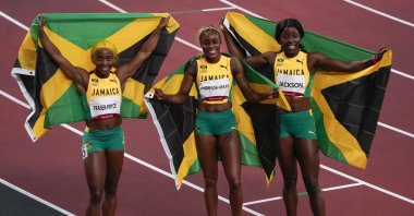 Elaine Thompson-Herah (C) of Jamaica, celebrates after winning the women's 100-meter final with Shelly-Ann Fraser-Pryce, of Jamaica, second place, and Shericka Jackson, of Jamaica, third, at the 2020 Summer Olympics, Saturday, July 31, 2021, in Tokyo. (AP Photo)