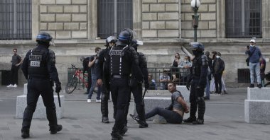 Police detain a protestor during a demonstration in Paris, France, July 31, 2021. (AP Photo)