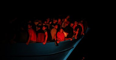 Migrants on an overcrowded wooden boat await rescue by the German NGO migrant rescue ship Sea-Watch 3 and the French NGO SOS Mediterranee ship Ocean Viking, during a rescue operation in international waters off the coast of Tunisia, the western Mediterranean Sea, July 31, 2021. (Reuters Photo)
