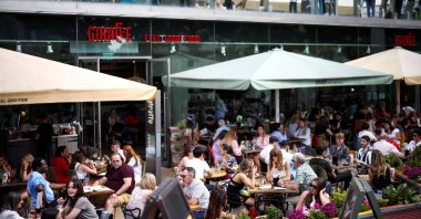 People sit at an outdoor restaurant on the South Bank during sunny weather in London, U.K., June 5, 2021. (Reuters Photo)