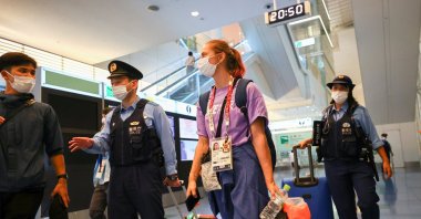 Belarusian athlete Krystsina Tsimanouskaya is escorted by police officers at Haneda international airport in Tokyo, Japan, Aug. 1, 2021.  (Reuters Photo)