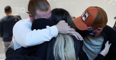 People meeting family members from the U.S. embrace at the international arrivals area of Terminal 5 in London's  Heathrow Airport, Britain, Aug. 2, 2021. (Reuters Photo)