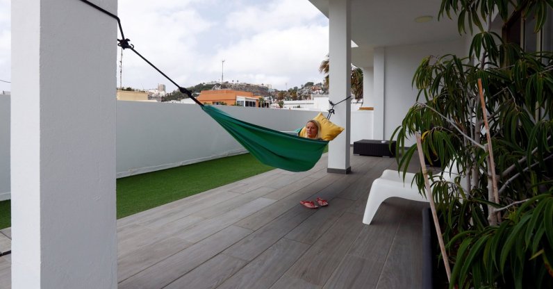 Olga Paul, a 34-year-old German who works remotely from Las Palmas De Gran Canaria, relaxes in a hammock amid the COVID-19 outbreak, in Gran Canaria, Spain, July 23, 2021. (Reuters Photo)