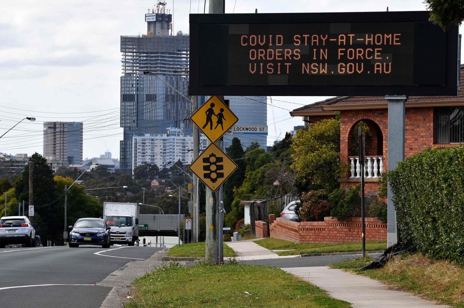 A stay-at-home message is displayed on a screen in western Sydney during the city's prolonged COVID-19 coronavirus lockdown, Sydney, Australia, Aug. 2, 2021. (AFP Photo)