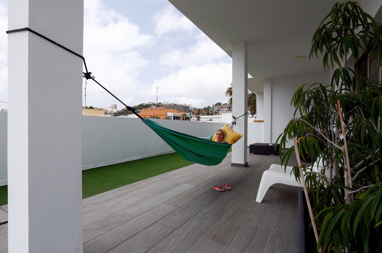 Olga Paul, a 34-year-old German who works remotely from Las Palmas De Gran Canaria, relaxes in a hammock amid the COVID-19 outbreak, in Gran Canaria, Spain, July 23, 2021. (Reuters Photo)