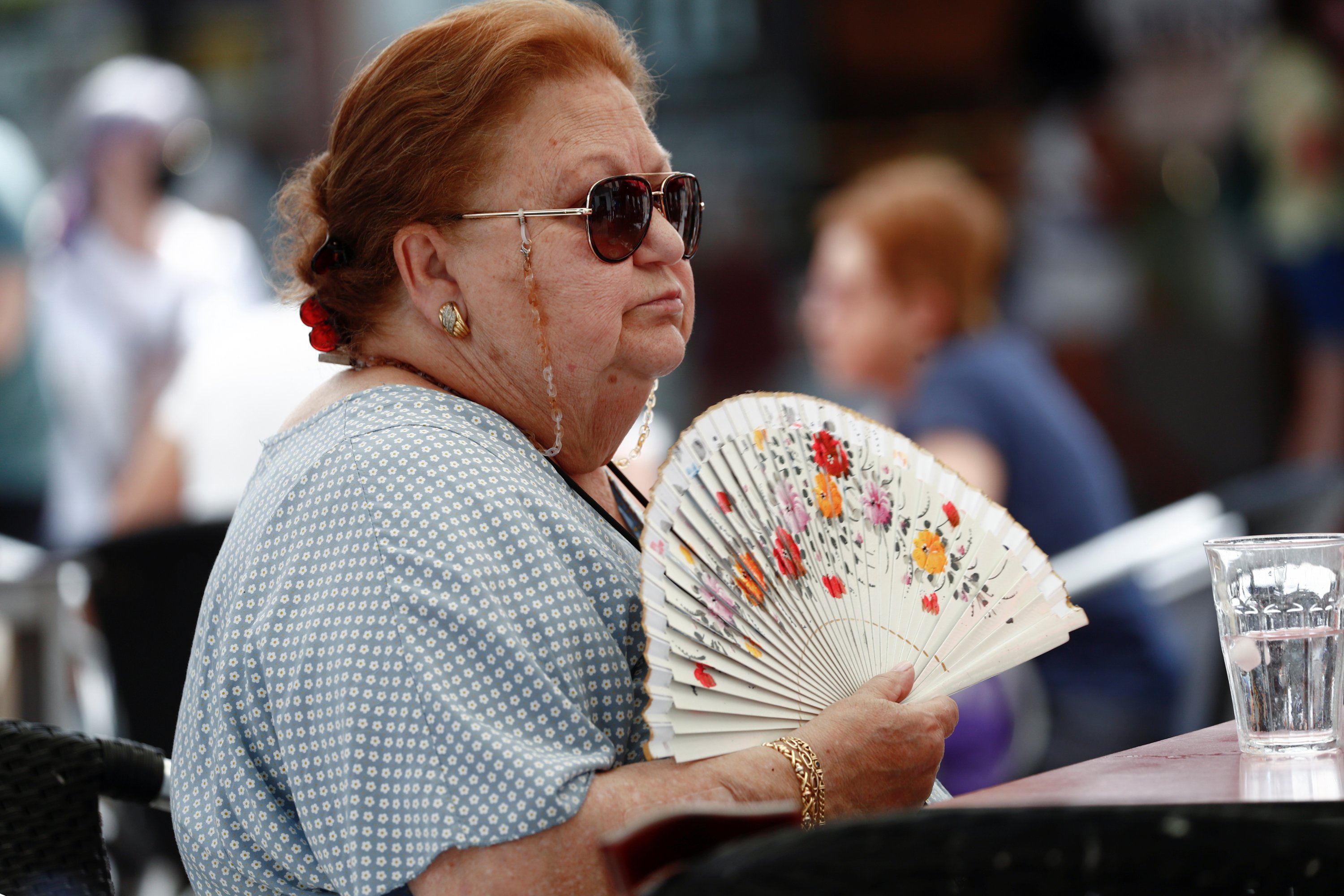 A woman uses a fan to cool off as heatwave hits the country, in Madrid, Spain, July 10, 2021. (Reuters Photo) 