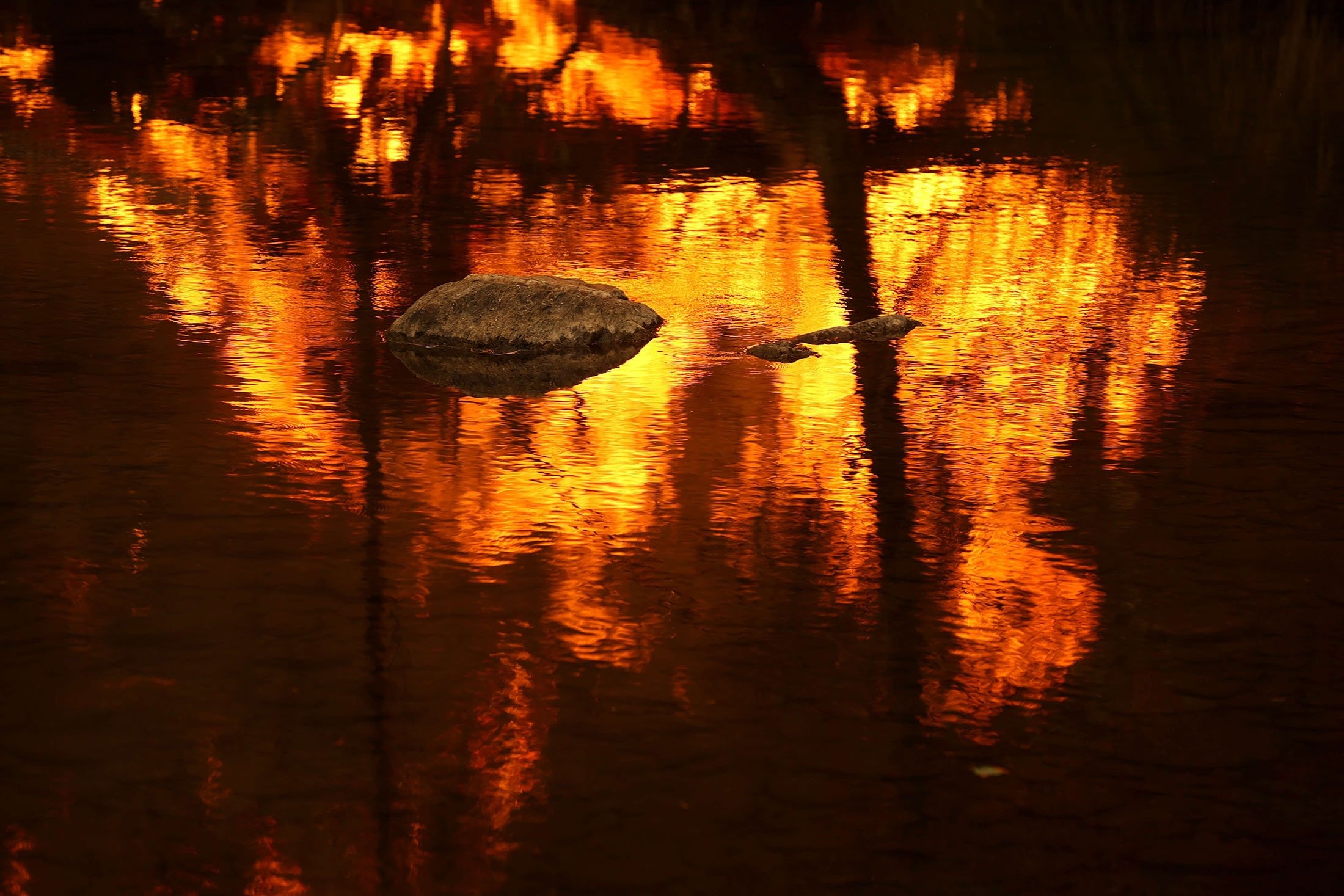 Flames are reflected in the Feather River as the Dixie Fire burns in the area near Quincy, California, U.S., July 26, 2021. (AFP Photo)