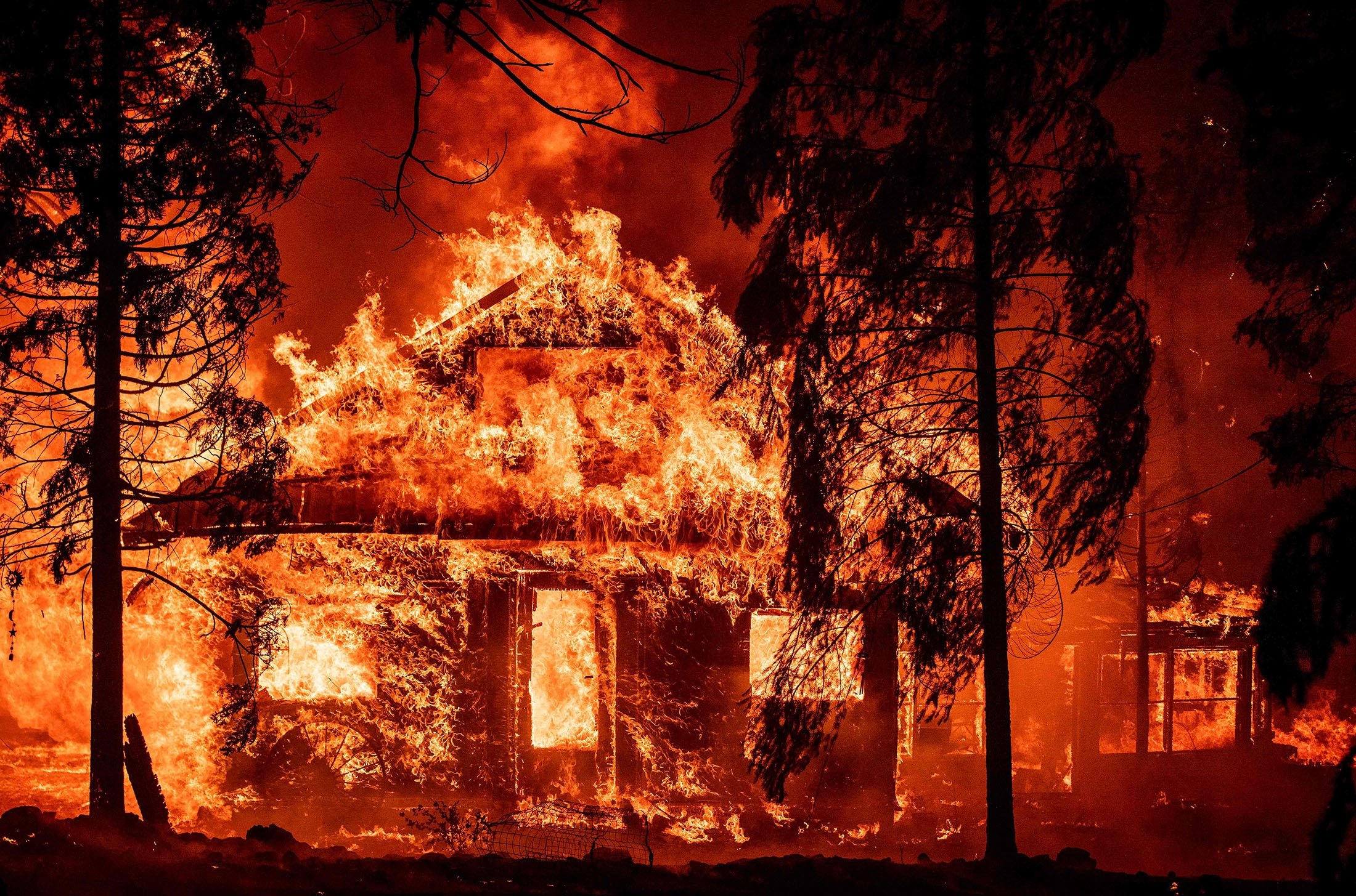 A home burns during the Dixie fire, in the Indian Falls neighborhood of unincorporated Plumas County, California, U.S., July 24, 2021. (AFP Photo)