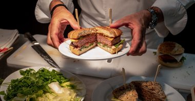 Chef Nicolas Maire prepares a vegetable burger at the headquarters of Swiss group Firmenich, in Satigny near Geneva, Switzerland, on June 30, 2021. (AFP Photo)