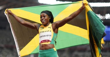 Elaine Thompson-Herah, of Jamaica, reacts after winning the final of the women's 200-meters at the 2020 Summer Olympics, Tuesday, Aug. 3, 2021, in Tokyo. (AP Photo/David Goldman)