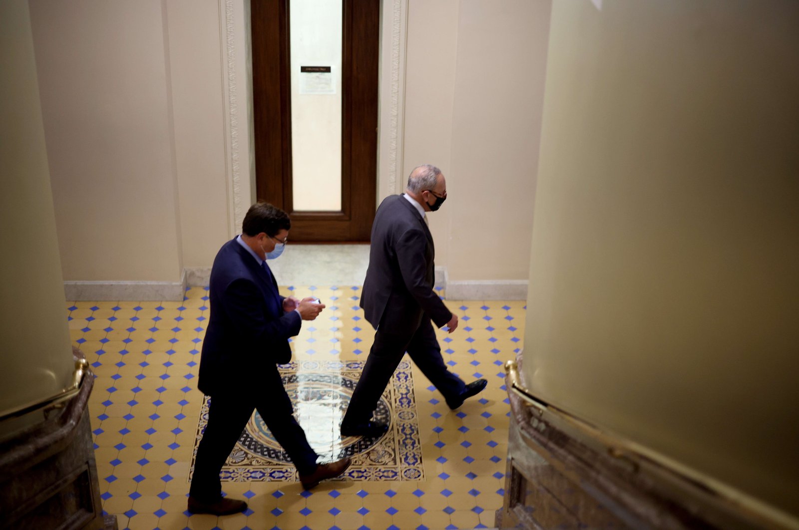 U.S. Senate Majority Leader Chuck Schumer (D-NY) (R) walks through the Capitol Building during a series of amendment votes in Washington, D.C., U.S., Aug. 2, 2021. (AFP Photo)