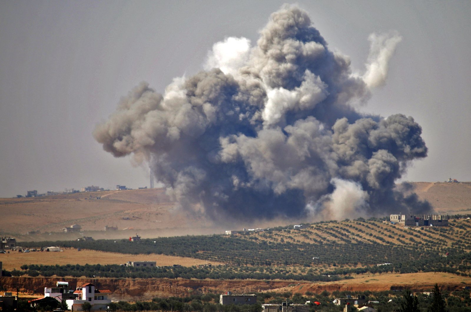 In this file photo taken on July 5, 2018, smoke rises above rebel-held areas of the city of Daraa, during reported airstrikes by Syrian regime forces. (AFP Photo)