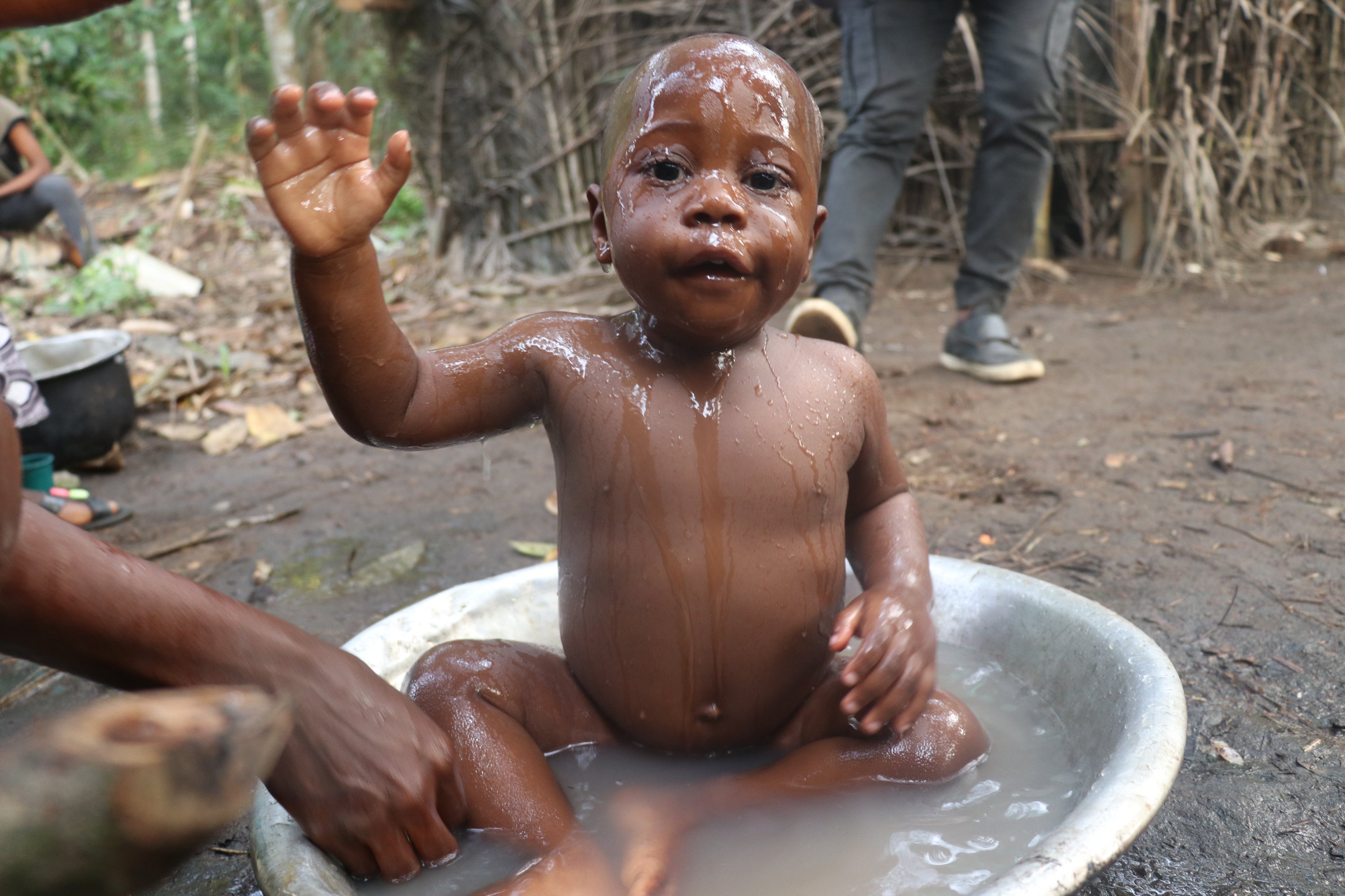 A Pygmy baby having a bath in Bikuitsi-Njule, Cameroon, Aug. 2, 2021. (AA Photo)