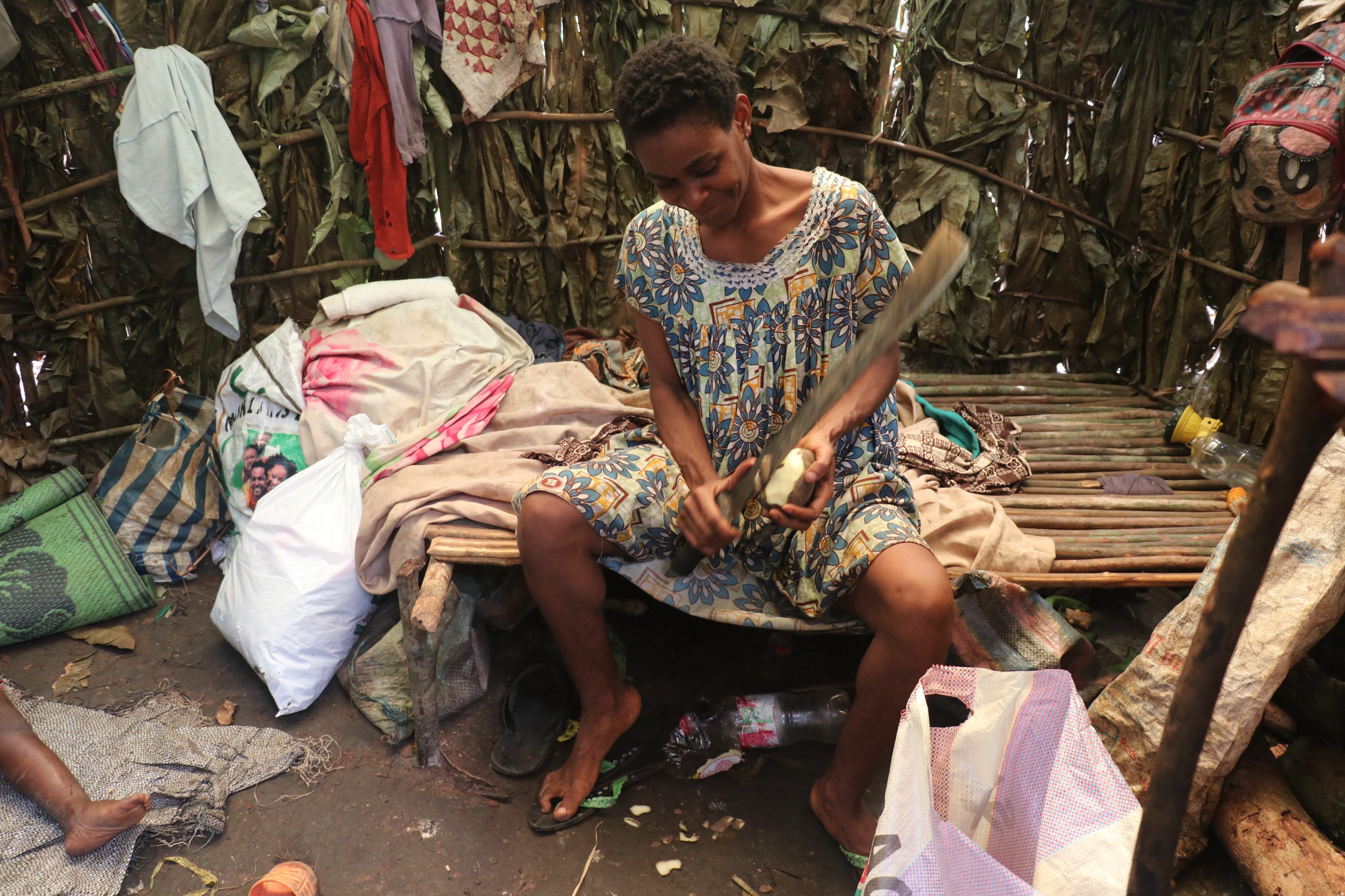 A Pygmy woman cuts a fruit in Bikuitsi-Njule, Cameroon, Aug. 2, 2021. (AA Photo)