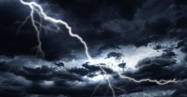 Lightning strike against the background of a cloudy dark sky. (Shutterstock Photo)