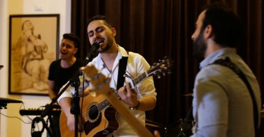 Palestinian accountant, Raji el-Jaru, sings and plays the guitar during a rehearsal for the first rock music band in Gaza City, Palestine, Aug. 1, 2021. (REUTERS Photo)
