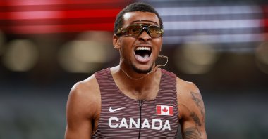 Canada's Andre De Grasse celebrates winning Tokyo 2020 Olympics men's 200-meter final at the Olympic Stadium, Tokyo, Japan, Aug. 4, 2021.