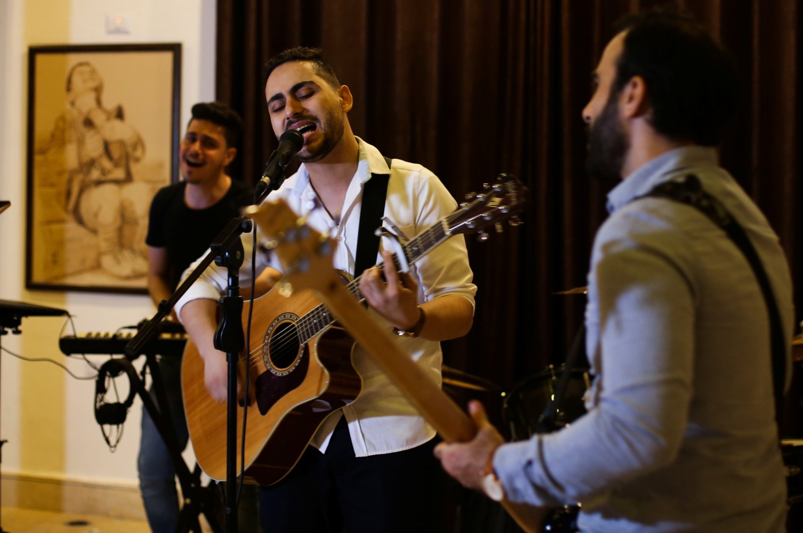 Palestinian accountant, Raji el-Jaru, sings and plays the guitar during a rehearsal for the first rock music band in Gaza City, Palestine, Aug. 1, 2021. (REUTERS Photo)