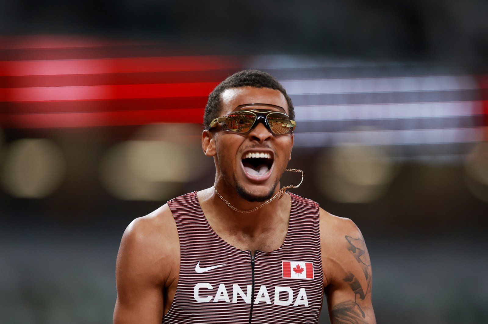 Canada's Andre De Grasse celebrates winning Tokyo 2020 Olympics men's 200-meter final at the Olympic Stadium, Tokyo, Japan, Aug. 4, 2021.