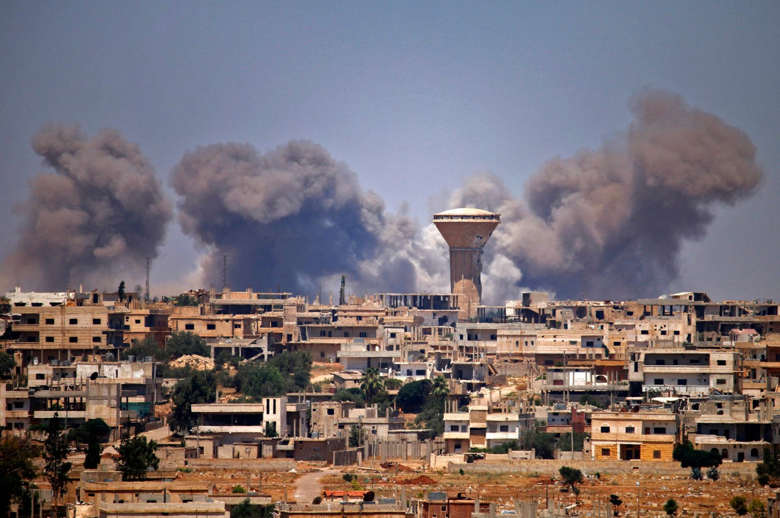 Smoke rises above opposition-held areas of the city of Daraa during reported airstrikes by Syrian regime forces, southern Syria, July 5, 2018. (AFP Photo)