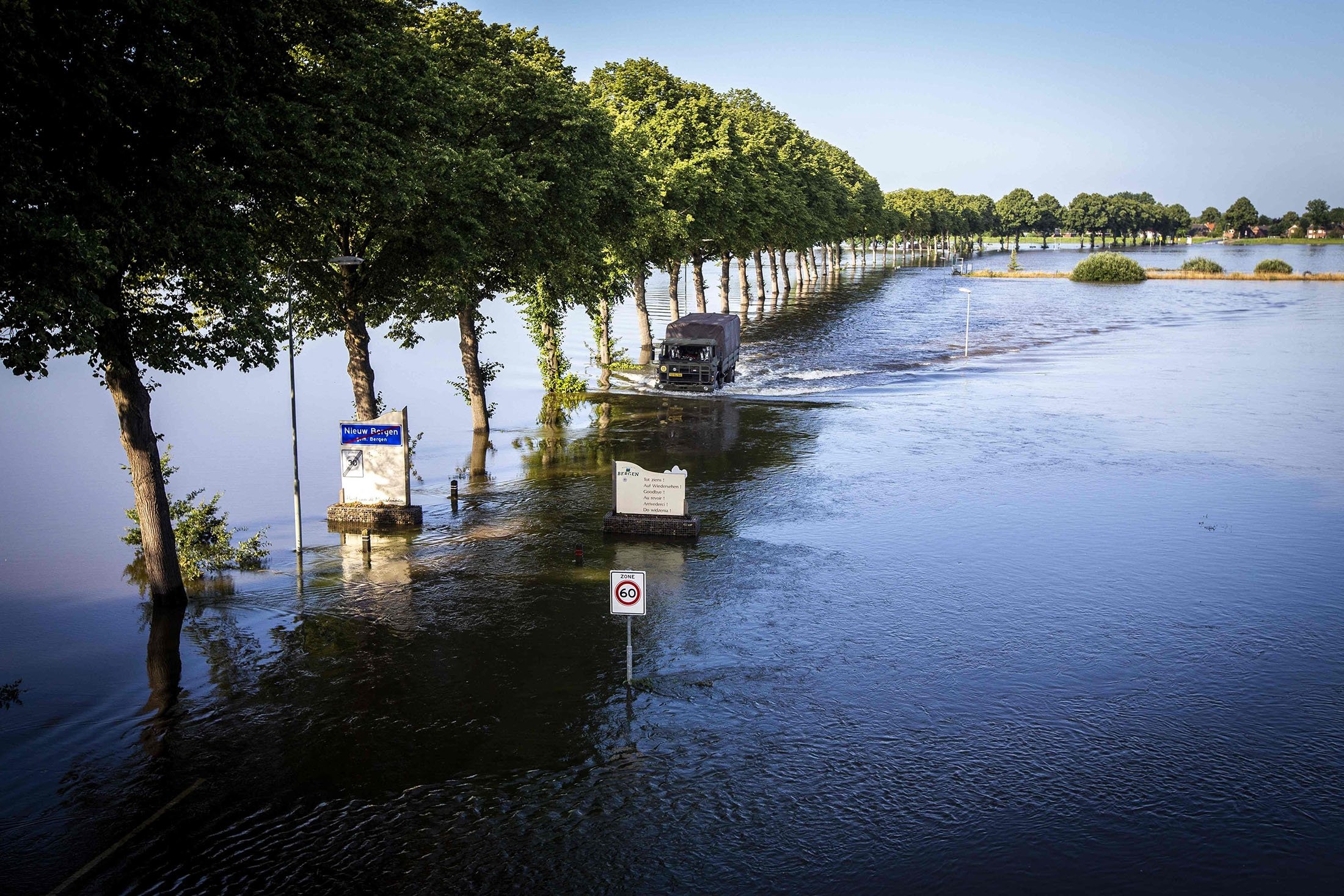 Residents cross a flooded area between Bergen and Nieuw Bergen, onboard a shuttle service operated by the Dutch army, after major flooding in the southern province of Limburg, the Netherlands, July 19, 2021. (AFP Photo)