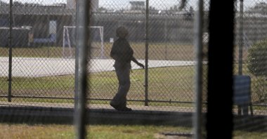 A guard walks on a path between yards during a media tour inside the Winn Correctional Center, in Winnfield, Louisiana, U.S., Sept. 26, 2019. (AP Photo)