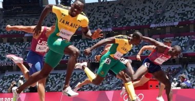 Jamaica's Hansle Parchment (2nd L) crosses the finish line to win gold in the Tokyo 2020 Olympics men's 110-meter hurdles at the Olympic Stadium, Tokyo, Japan, Aug. 5, 2021. (Reuters Photo)