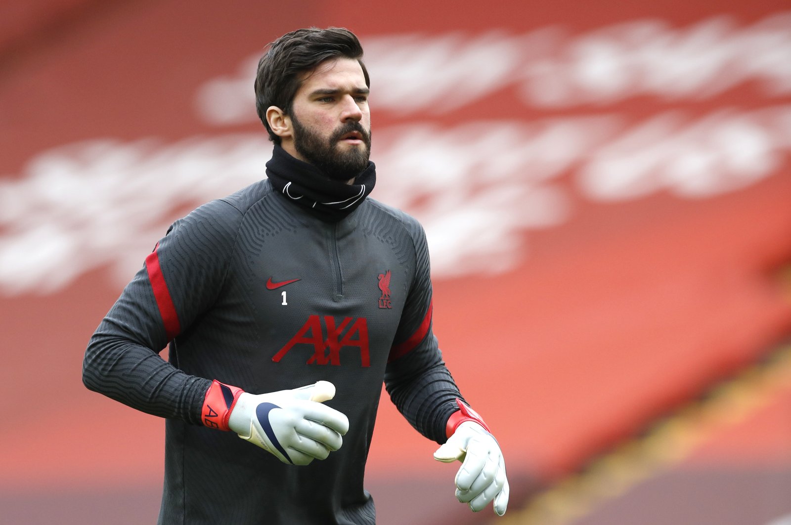 Liverpool's goalkeeper Alisson warms up prior to their English Premier League match against Fulham at Anfield, Liverpool, England, March 7, 2021.